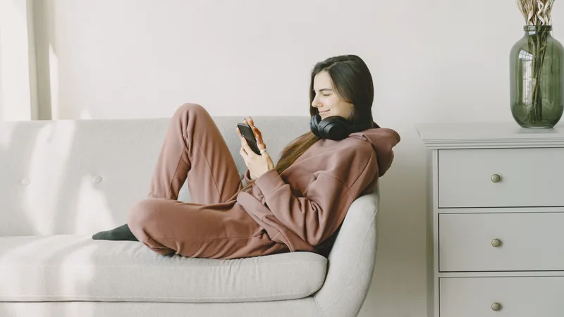 Woman applying for Credit Cube loan online easily from home using smartphone
